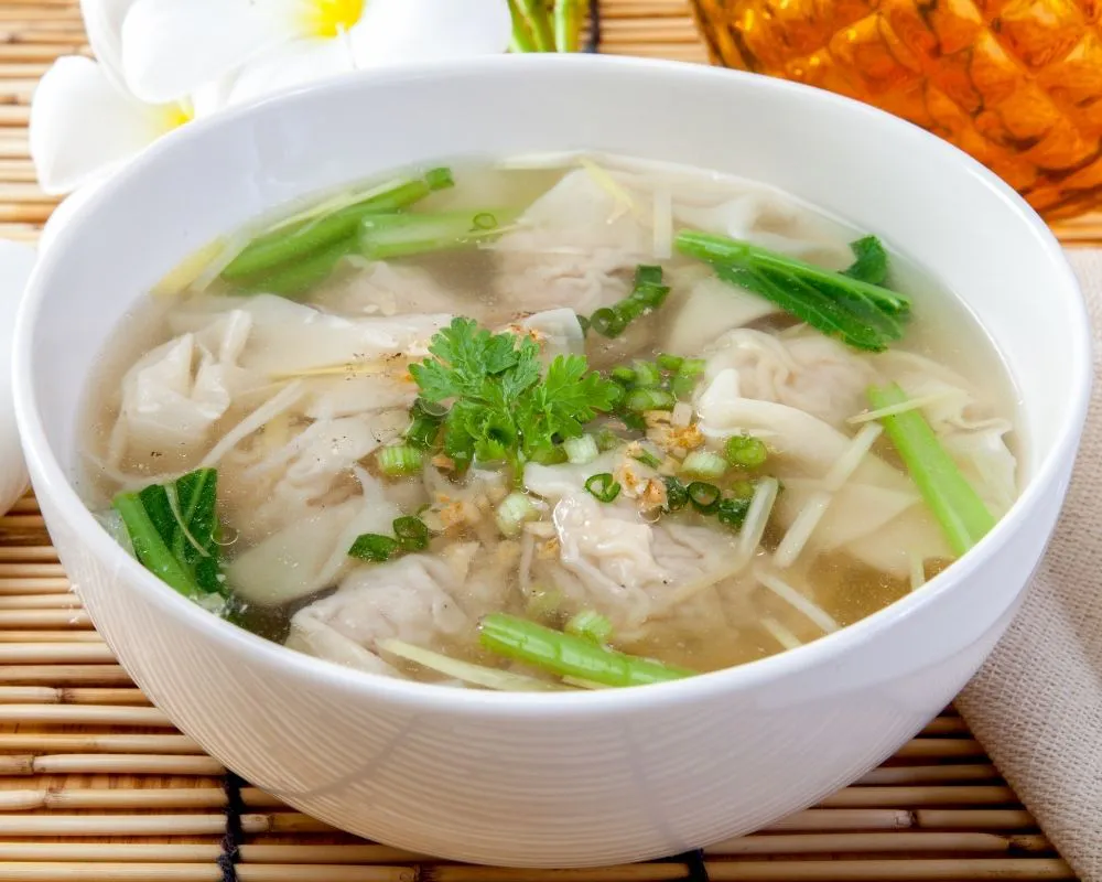 Clear wonton soup with greens and herbs at ZOEN RAMEN & POKE, Ramen Restaurant in College Station