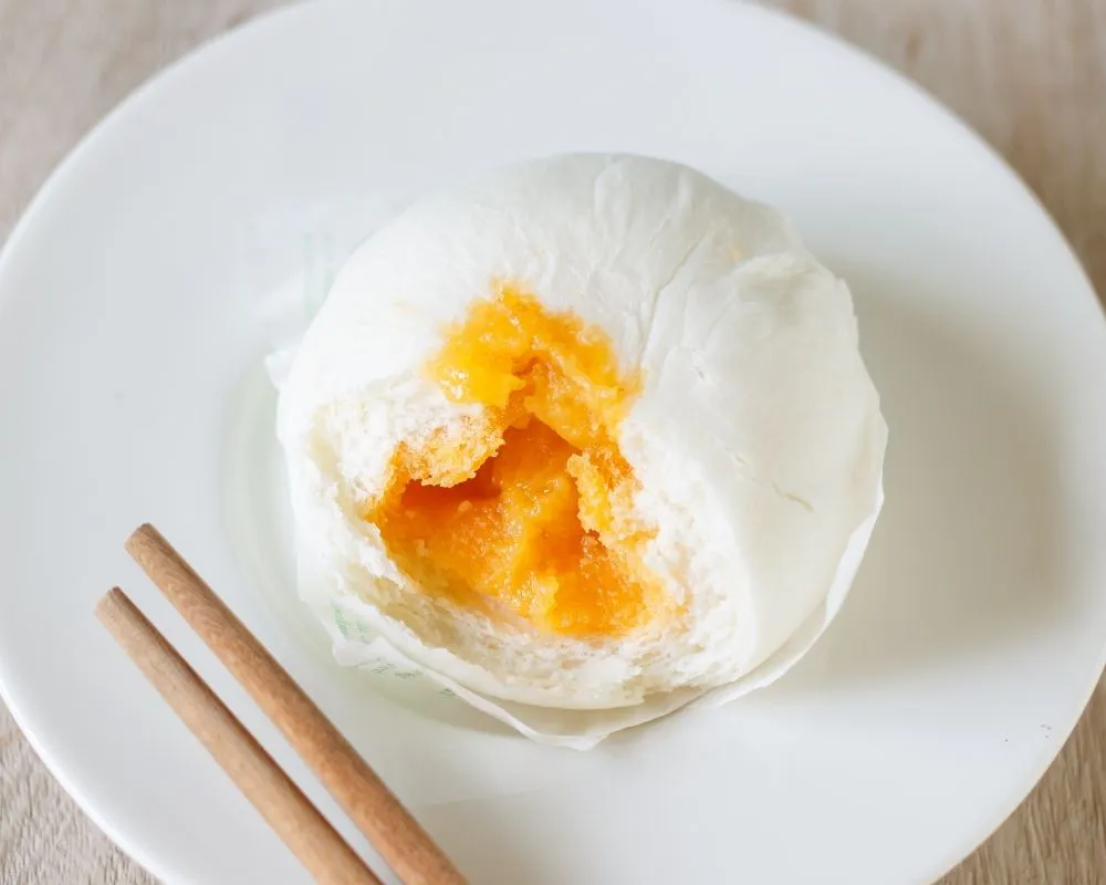 Creamy salted egg yolk bun, partially eaten at ZOEN RAMEN & POKE, Ramen Restaurant in College Station