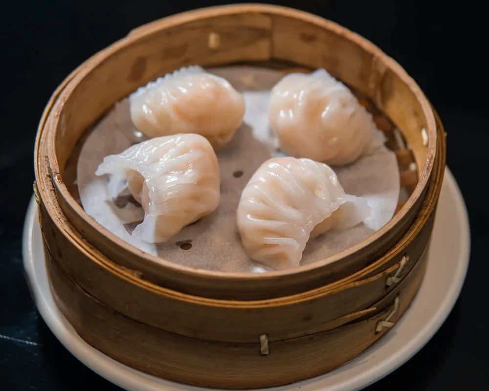 Steamed shrimp dumplings in bamboo steamer at ZOEN RAMEN & POKE, Ramen Restaurant in College Station